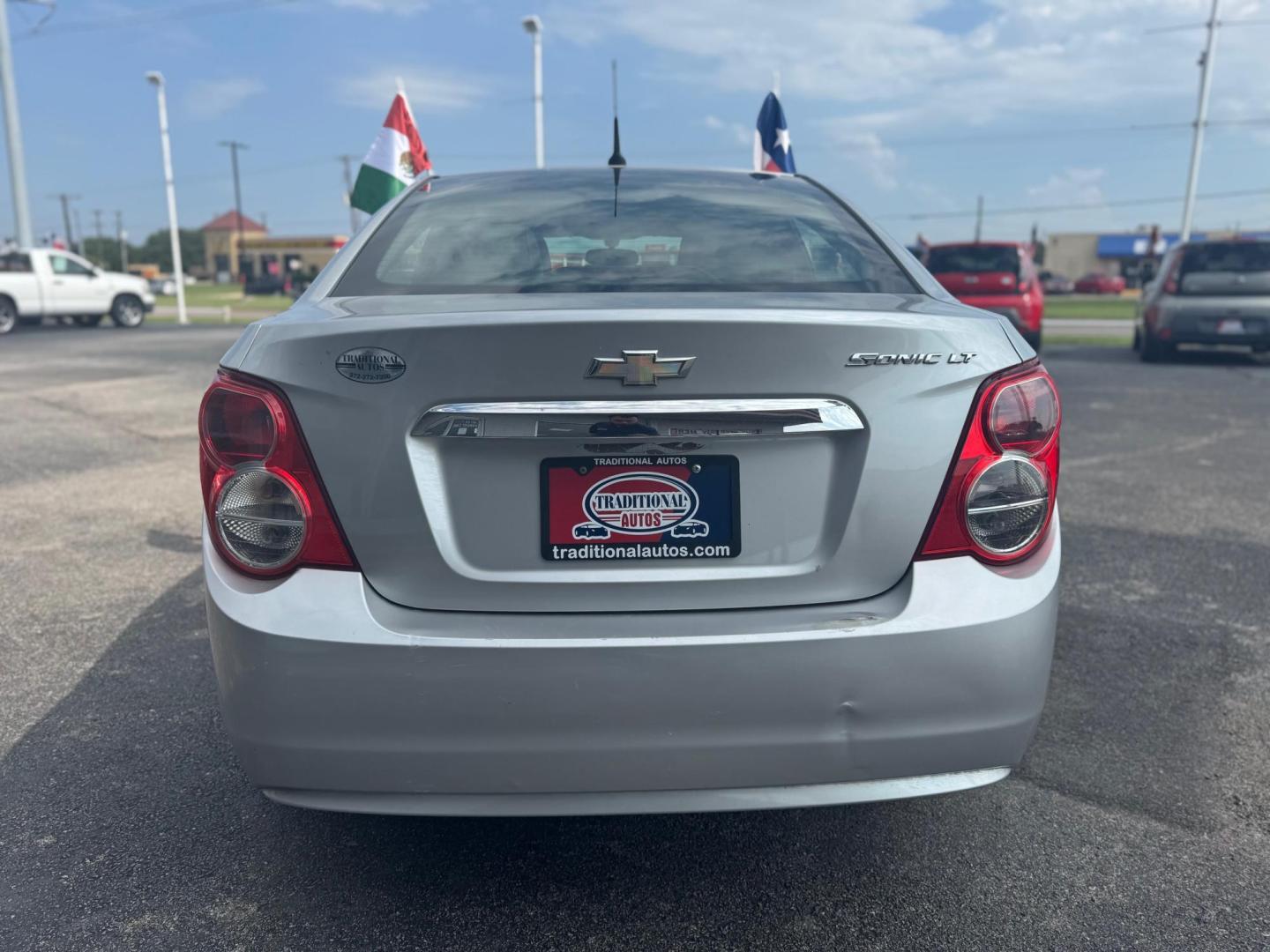 2014 SILVER CHEVROLET SONIC LT LT Auto Sedan (1G1JC5SH9E4) with an 1.8L L4 DOHC 24V engine, 6-Speed Automatic transmission, located at 10740 Forest Lane, Dallas, TX, 75243, (972) 272-7300, 32.908588, -96.701813 - Photo#2