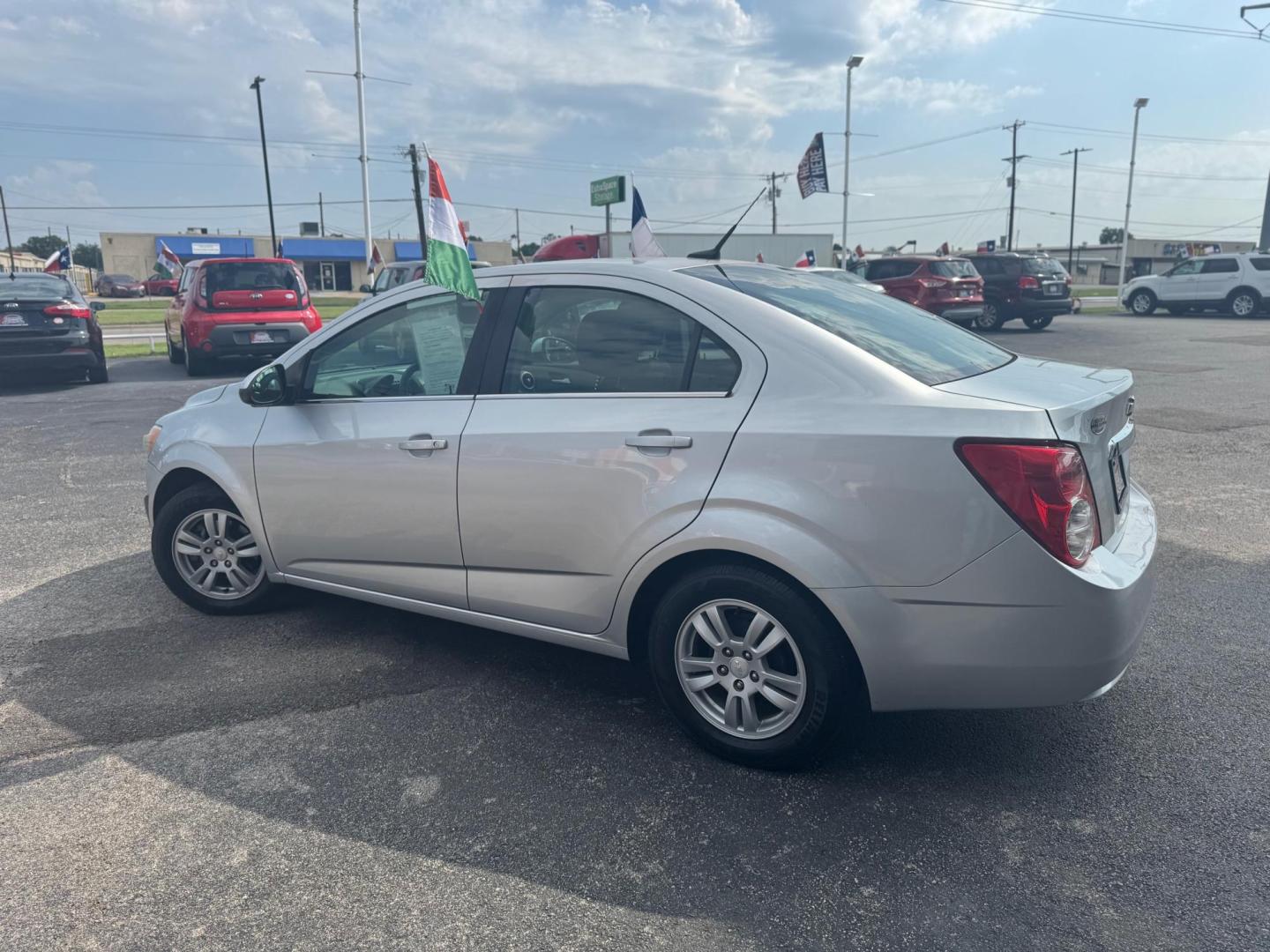 2014 SILVER CHEVROLET SONIC LT LT Auto Sedan (1G1JC5SH9E4) with an 1.8L L4 DOHC 24V engine, 6-Speed Automatic transmission, located at 10740 Forest Lane, Dallas, TX, 75243, (972) 272-7300, 32.908588, -96.701813 - Photo#3