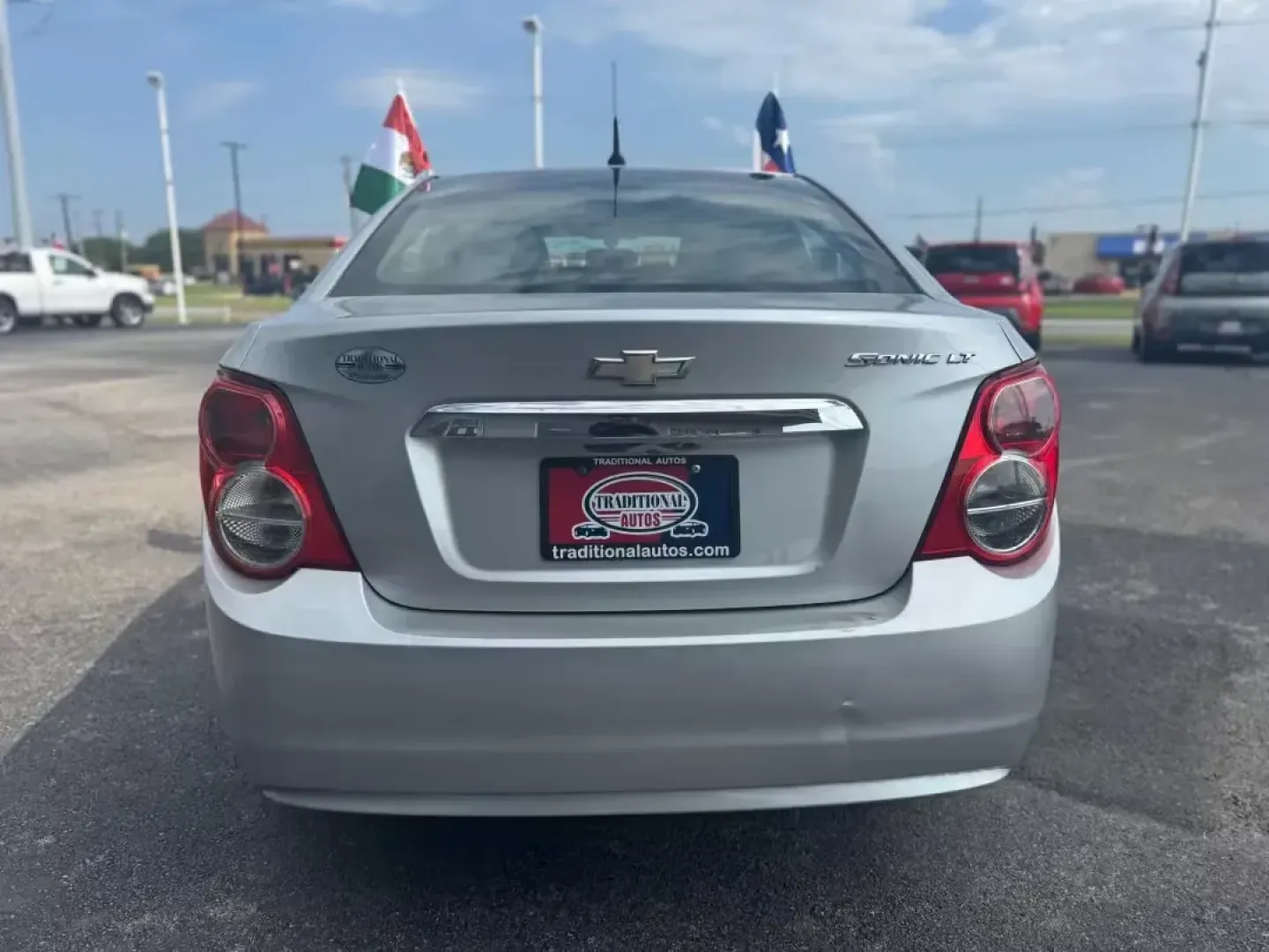 2014 SILVER Chevrolet Sonic LT Auto Sedan (1G1JC5SH9E4) with an 1.8L L4 DOHC 24V engine, 6-Speed Automatic transmission, located at 10740 Forest Lane, Dallas, TX, 75243, (972) 272-7300, 32.908588, -96.701813 - **Unleash Your Daily Adventures with this 2014 Chevrolet Sonic LT Auto Sedan!** <br /> <br /> If you're searching for an affordable vehicle that combines style, comfort, and practicality, look no further than this 2014 Chevrolet Sonic LT Auto Sedan, available now at Traditional Autos in Dallas, TX. - Photo#2